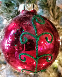 Red ornament with gold & green swirl design- shatterproof 3"