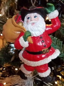 Santa w cowboy hat/brown sack over shoulder resin 4"