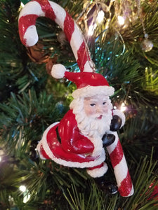 Santa holding candy cane ornament resin 6"