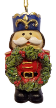 Load image into Gallery viewer, Red Nutcracker Ornament with Blue Hat Holding Christmas Wreath
