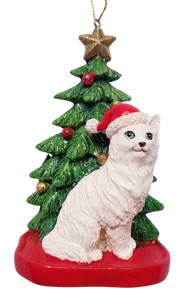 White Cat Sitting Under A Christmas Tree Ornament Wearing Red Santa Hat