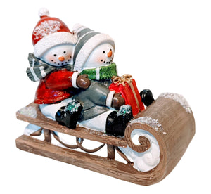 Snowman Sledding Figurine Holding Christmas Gift