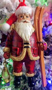 Santa ornament with skis & gold lantern-resin 3.5"