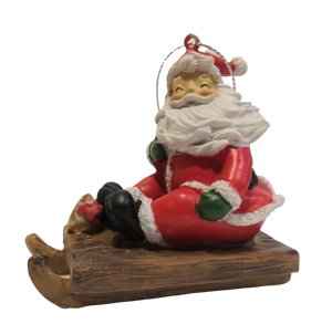 Santa on a sled Ornament with gold bell 3"x2.5" resin