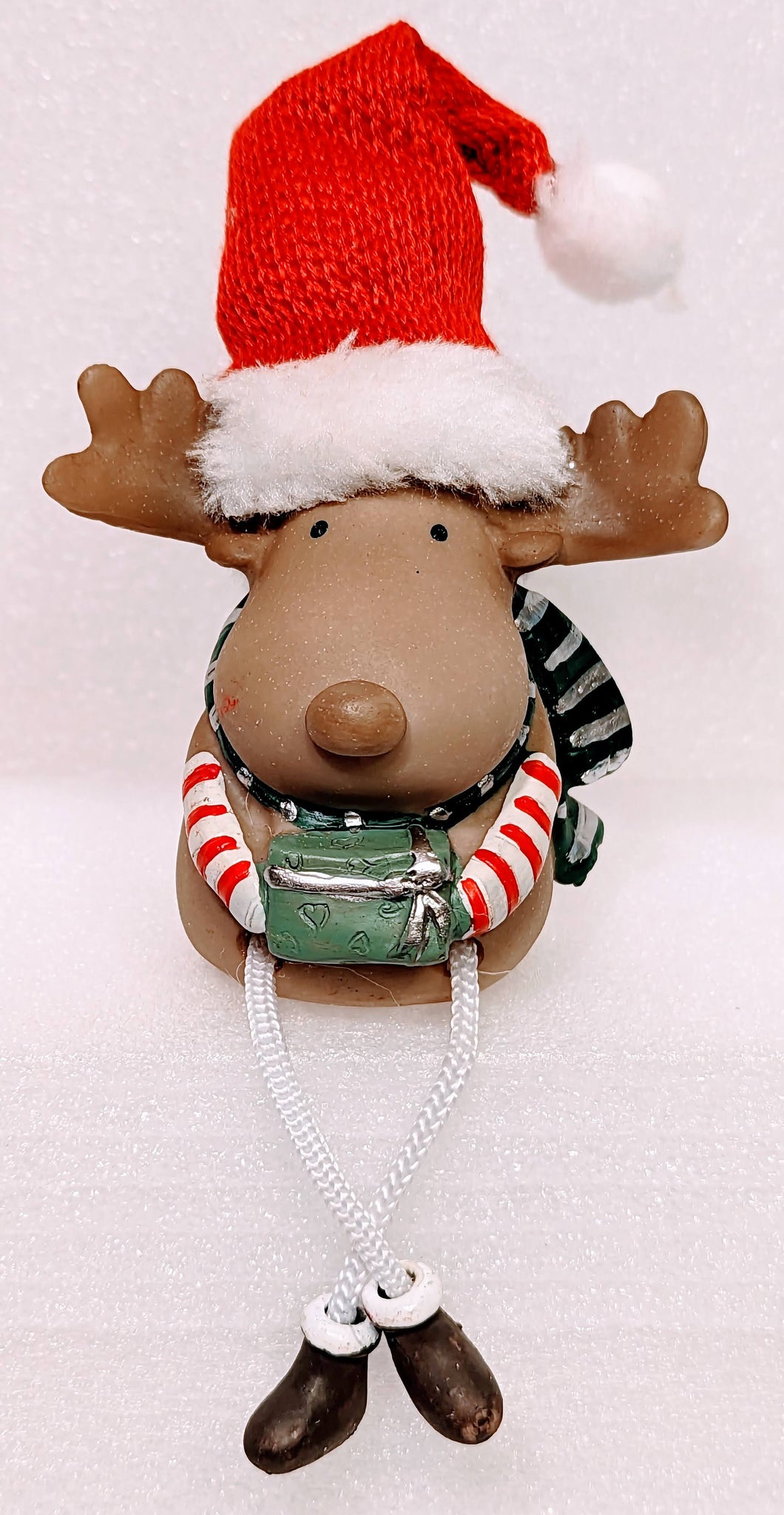 Merry Reindeer Shelf Sitter with Red Santa Hat Holding Christmas Gift